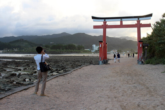 Visitors at torii gate of Aoshima Shrine in the island. Located in Miyazaki