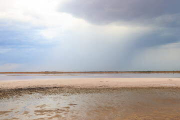 Dark storm clouds over a salt lake before a rain