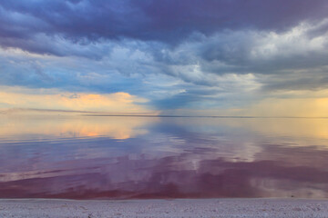 Dark storm clouds over a salt lake before a rain