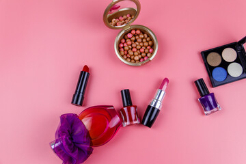 Obraz na płótnie Canvas Set of decorative cosmetics on a pink background. Top view, flat lay