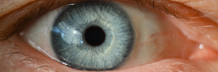 Blue male human eye retina closeup super macro. Laser correction vision concept