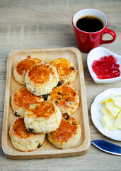 Close up Scone homemade with strawberry jam and butter on  wooden table backgrounds