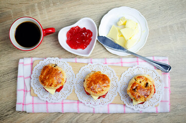 Scones homemade with strawberry jam and butter dessert on wooden table backgrounds above