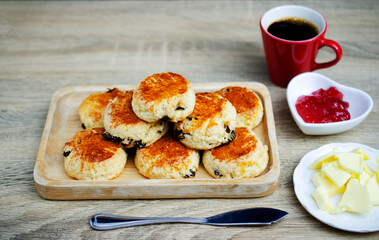 scones homemade with strawberry jam and red cup coffee on the white table