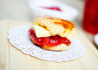 scones with strawberry jam on wooden plate for dessert food concept