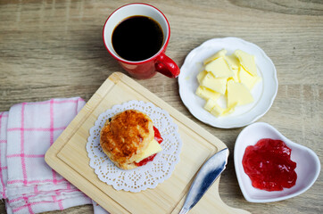 Tasty Scone with strawberry jam and butter for coffee times