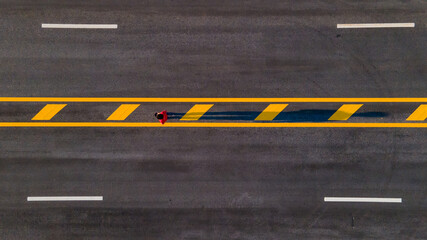 Long asphalt road with marking lines yellow stripes traffic on the road surface texture Background
