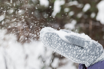 Flying snowflakes made of gray mittens. Winter. Snow.