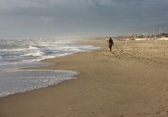 relaxing walks on the sandy beach of Versilia on a sunny day in Italian winter