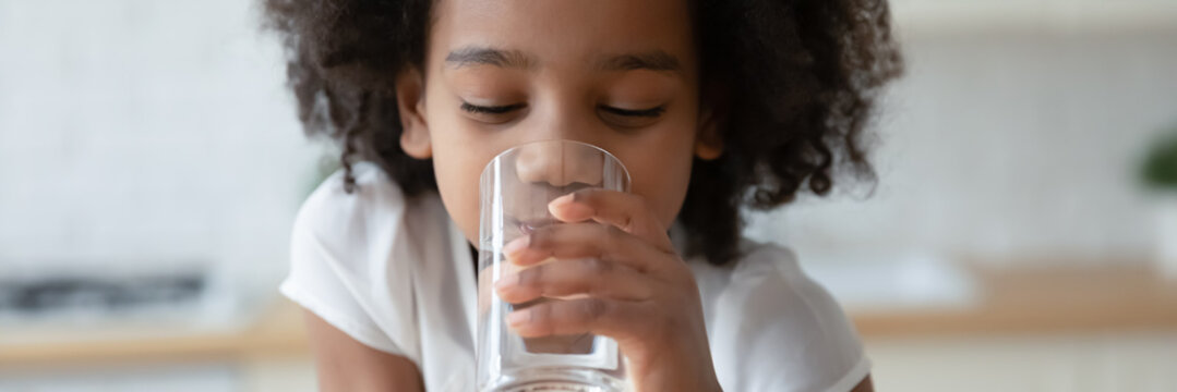 Thirsty Funny Small African Ethnicity Cute Kid Girl Drinking Fresh Pure Water, Refreshing During Day Or Enjoying Morning Healthcare Routine, Horizontal Photo Banner For Website Header Design.