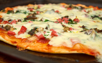 Pizza with mozzarella, fried mushrooms, sausage and parsley