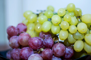 Red and White wine bunch of grapes in the black plate