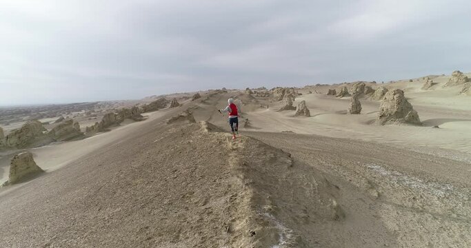 Woman trail runner cross country running  on sand desert dunes