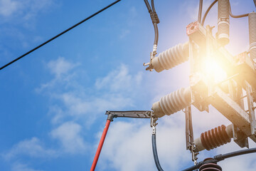 An electrician uses an insulating stick to close the disconnecting switch.