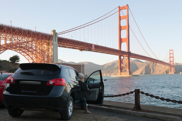 View of a girl coming out of the car near golden gate in San francisco