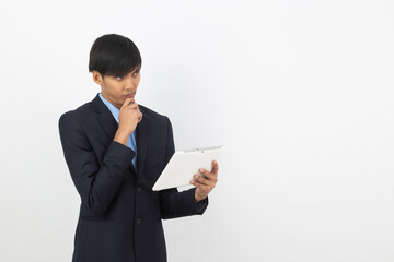 Young handsome asian business man using tablet computer with smiling isolated on white background.