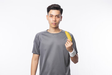 Young handsome asian sport man holding banana with smiling isolated on white background. Healthy lifestyle concept.