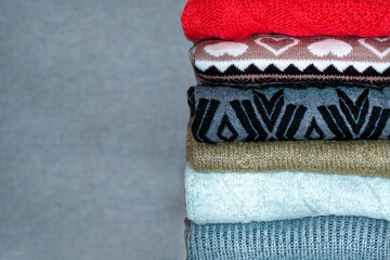 A stack of sweaters, jumpers. A Bunch of colored, woolen jumpers.  Layers, the texture of clothes