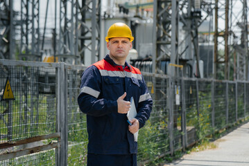 The energy engineer inspects the equipment of the substation. Power engineering. Industry.