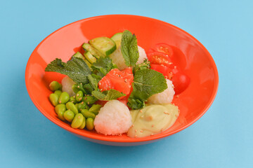 Rice salad with salmon fish, tomatoes, cucumbers and sauce. Japanese cuisine, healthy meal concept.