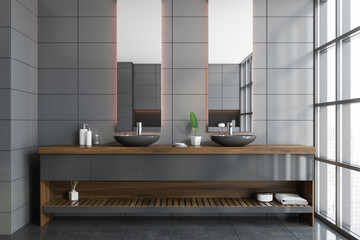 Double sink in gray tile bathroom