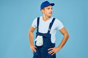 Working man in uniform of gloves loader rendering service blue background