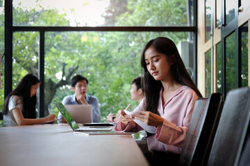 Businesswoman working with laptop in meeting room at office.