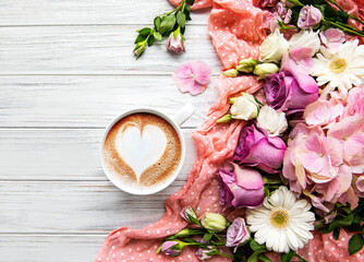 Pink flowers and cup of coffee