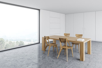 White dining room with wooden table and window