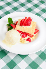 Napoleon cake with strawberries and vanilla ice cream. Italian cuisine concept, traditional Italian summer dessert.
