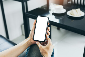 cell phone mockup blank white screen.woman hand holding texting using mobile on desk at coffee shop.background empty space for advertise.work people contact marketing business,technology
