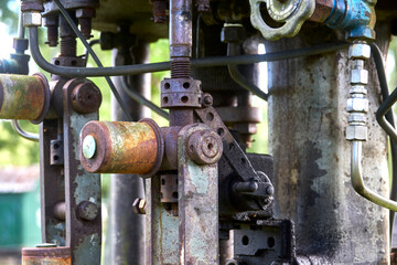 Valves, connection, fittings and steering wheels on an old mechanical pump