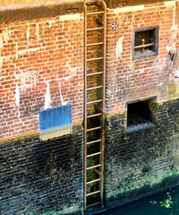 Ladder on the inner wall of a lock in a river, Aller near Celle, Germany