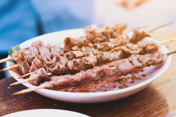The BBQ steak is sprinkled with aromatic spices and is appetizing to the tableware.