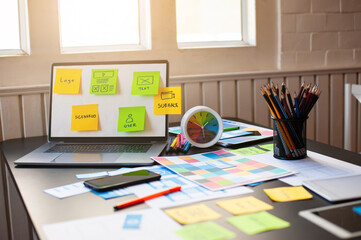 Concept of web and application design. Designer desks with laptops, papers and office supplies.