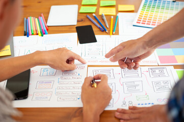 UX, UI designers draw website layouts and design mobile applications.