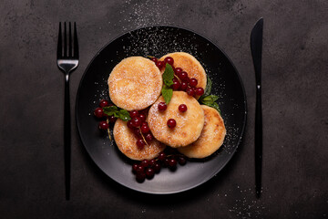 cottage cheese pancakes with red currants, mint and powdered sugar