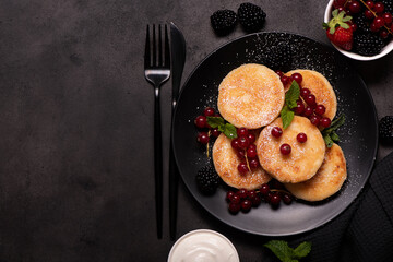 cottage cheese pancakes with red currants, mint and powdered sugar
