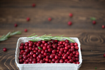 fresh ripe lingonberries in a craft box