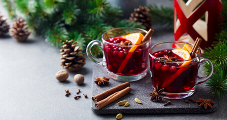 Mulled red wine with spices. Grey background. Copy space.