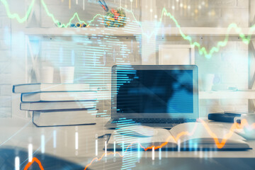 Stock market graph and table with computer background. Double exposure. Concept of financial analysis.