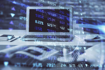 Financial chart drawing and table with computer on background. Double exposure. Concept of international markets.