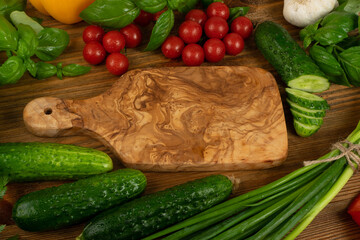 Sliced Cucumber with Green Vegetables on Rustic Cutting Board