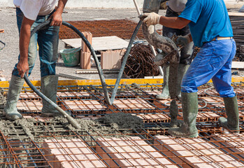 pouring concrete slab - concrete pouring during commercial concreting floors of buildings in construction