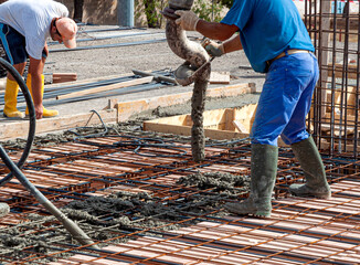 pouring concrete slab - concrete pouring during commercial concreting floors of buildings in...