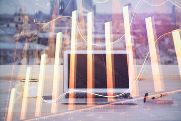Forex market graph hologram and personal computer on background. Multi exposure. Concept of investment.