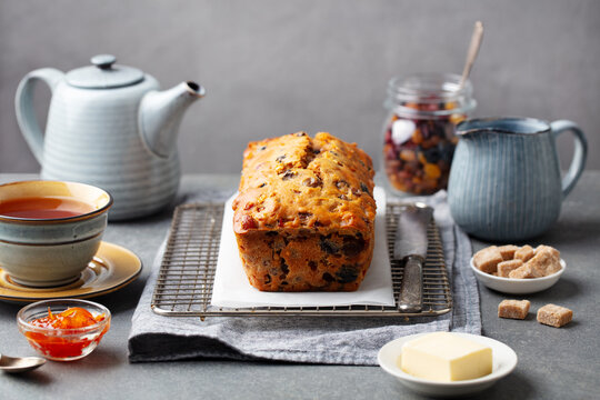 Fruit cake Bara Brith with cup of tea. Welsh traditional dessert. Grey background.