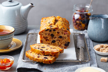 Fruit cake Bara Brith with cup of tea. Welsh traditional dessert. Grey background.