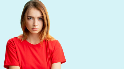 Worried woman portrait. Female rights. Disturbed insecure lady in red t-shirt looking at camera...