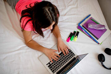 Caucasian schoolgirl with digital tablet  doing school homework